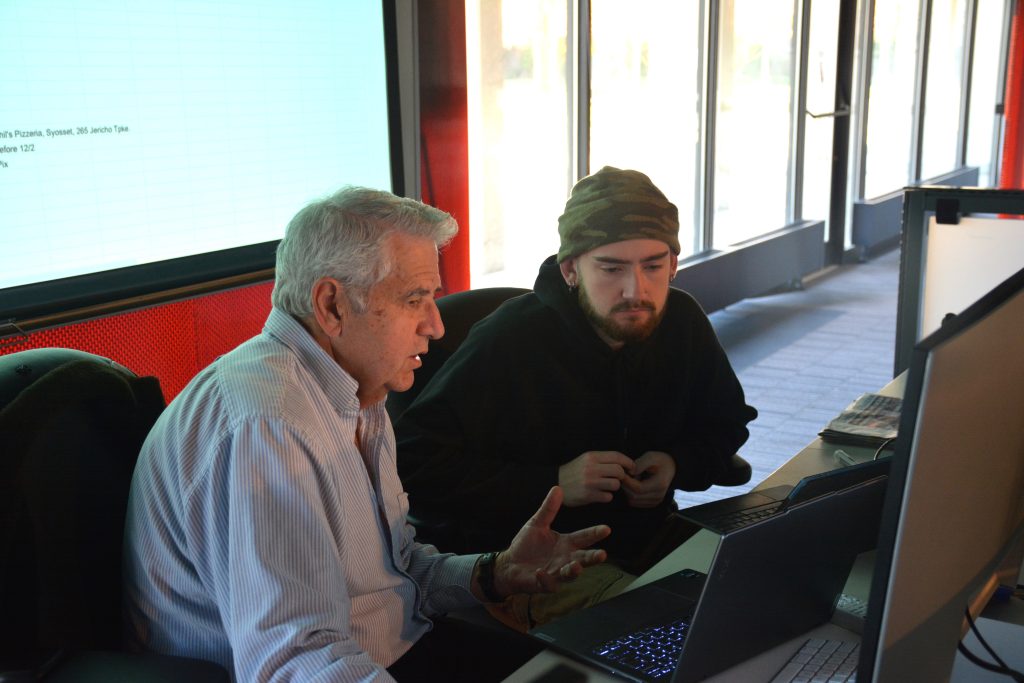George Giokas with a student in front of a computer