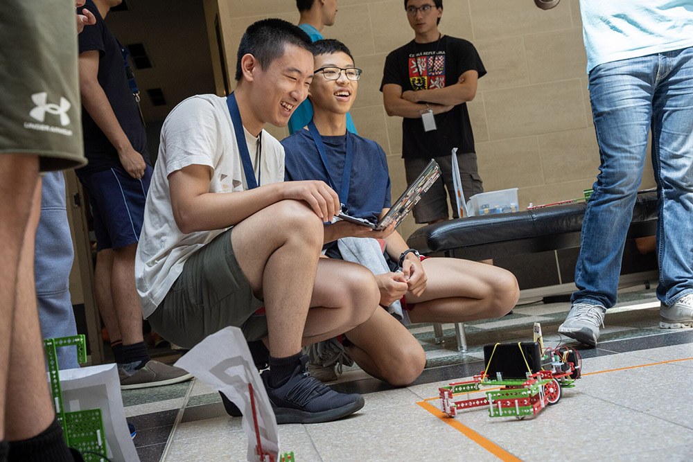 Two students testing a remote control car