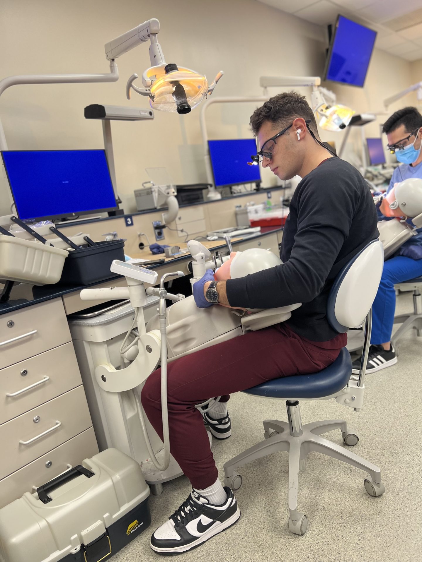 Axelrod practices on a training model during his time as a dental student.