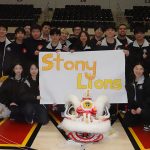 Students holding a Stony Lions sign