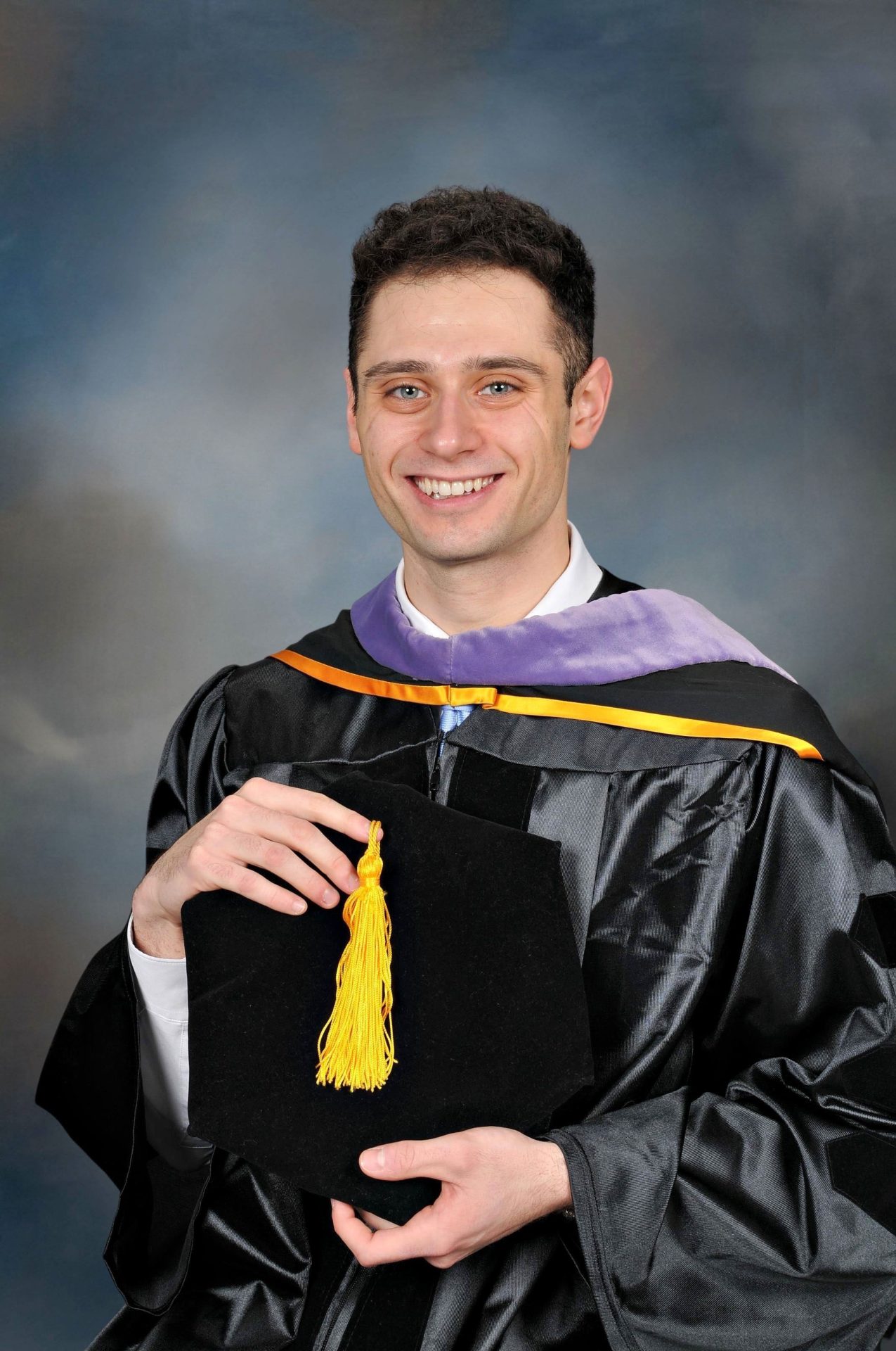 Axelrod's formal graduation portrait. He is wearing black School of Dental Medicine regalia.