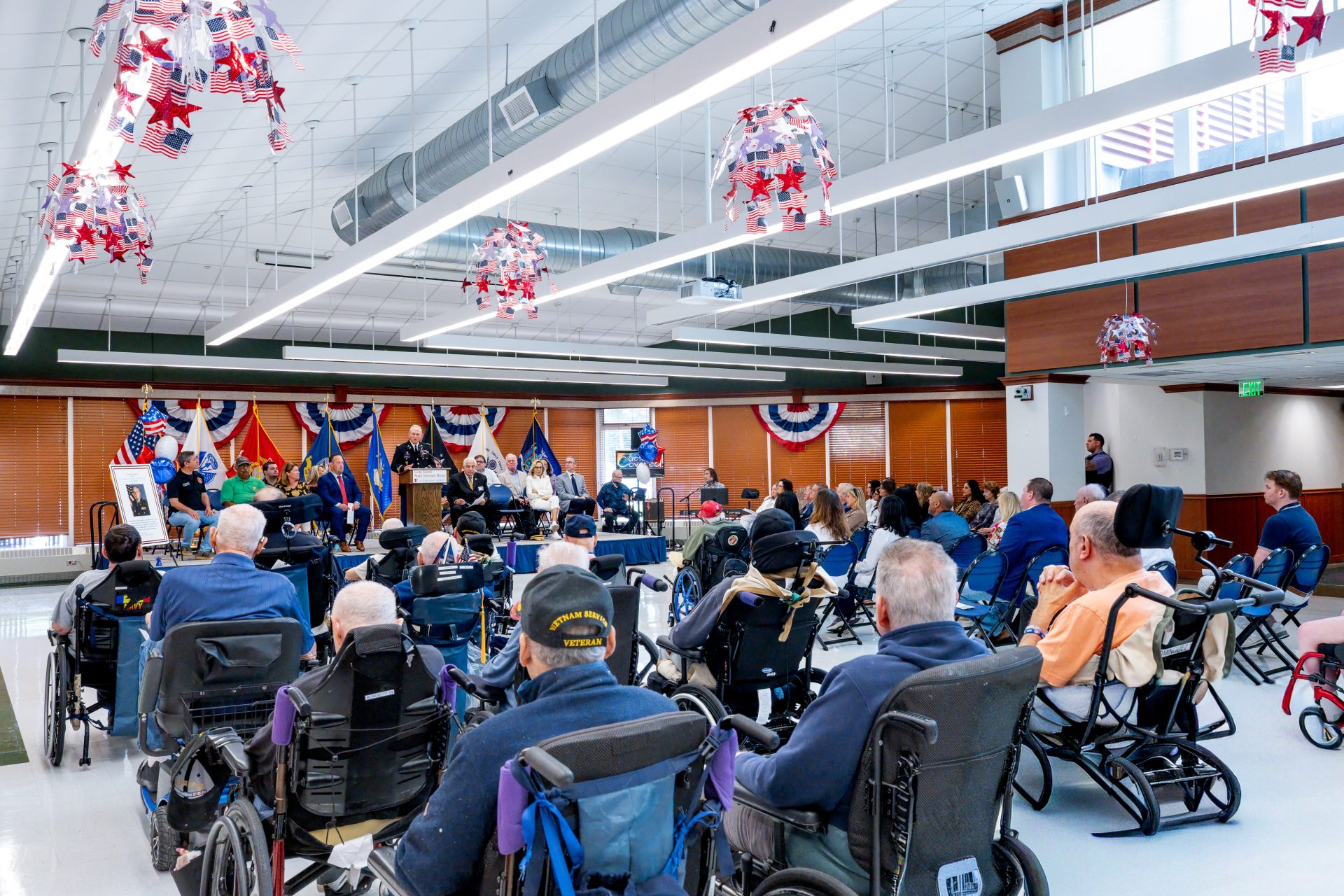 Col. E. David Woycik Jr. at a podium speaking to a room