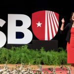 President Goldsmith in front of the SBU letters
