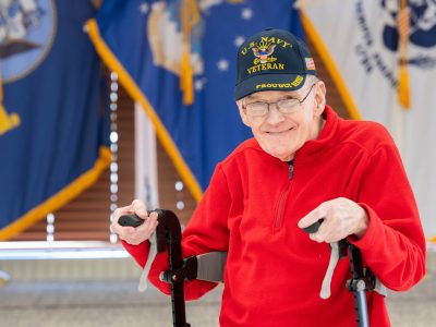 Paul Walwanis, a veteran in front of flags at the Vets Home